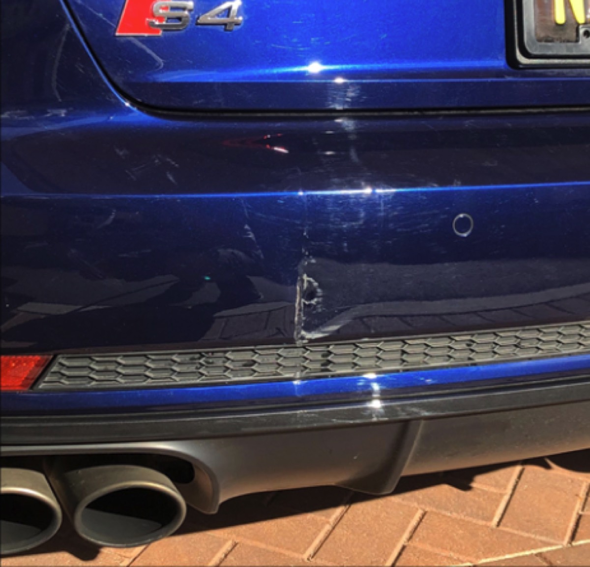 Mobile Bumper Repair before in Brea, CA, Deep scrape and gouge on an Audi S4 rear bumper, repaired and refinished on-site in Orange County.