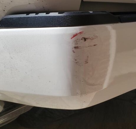 Scratch Repair before in Brea, CA, Scuffed and scraped white bumper corner, sanded, refinished, and PPG color-matched on-site. No trace of the damage left behind.
